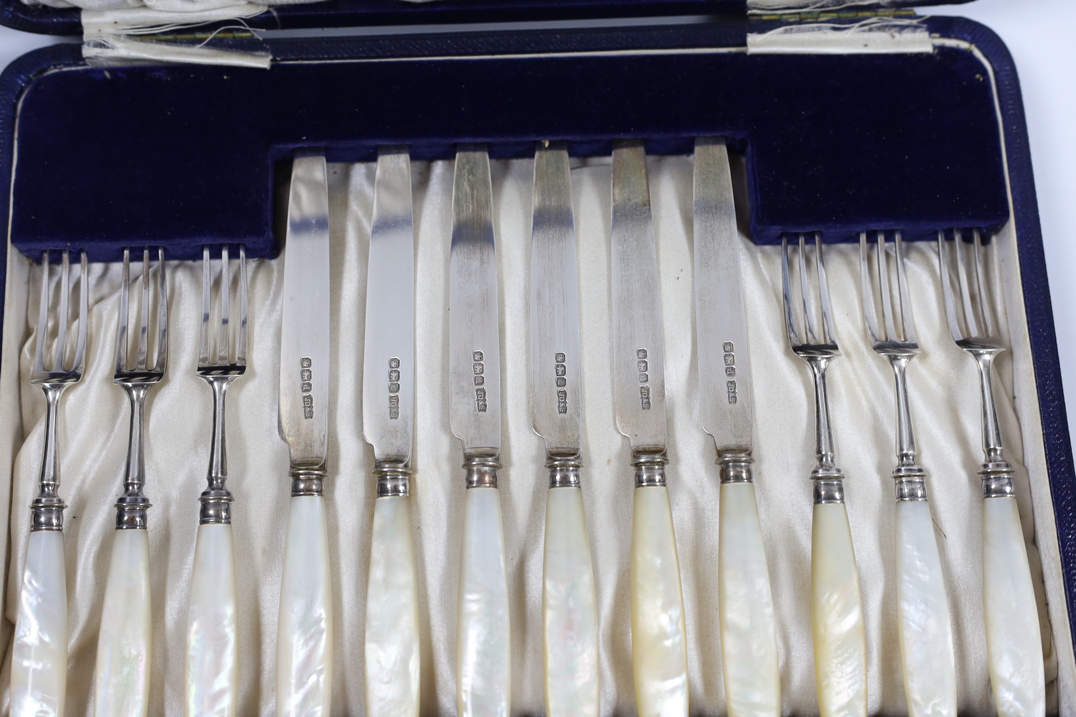 A cased set of six pairs of George V mother of pearl handled silver dessert eaters, James Dixon & Sons, Sheffield, 1921.